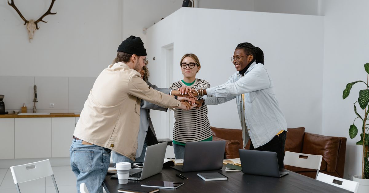 A diverse group of colleagues collaborating around a table in a modern office