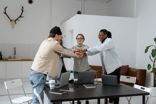 A diverse group of colleagues collaborating in a modern office setting, showcasing teamwork.