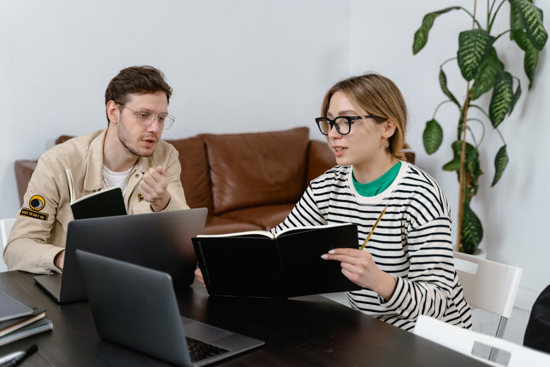 Man and Woman Discussing riddle in Workplace