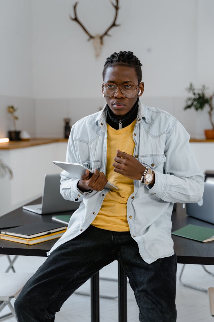 Man With Dreadlocks Holding An Ipad 