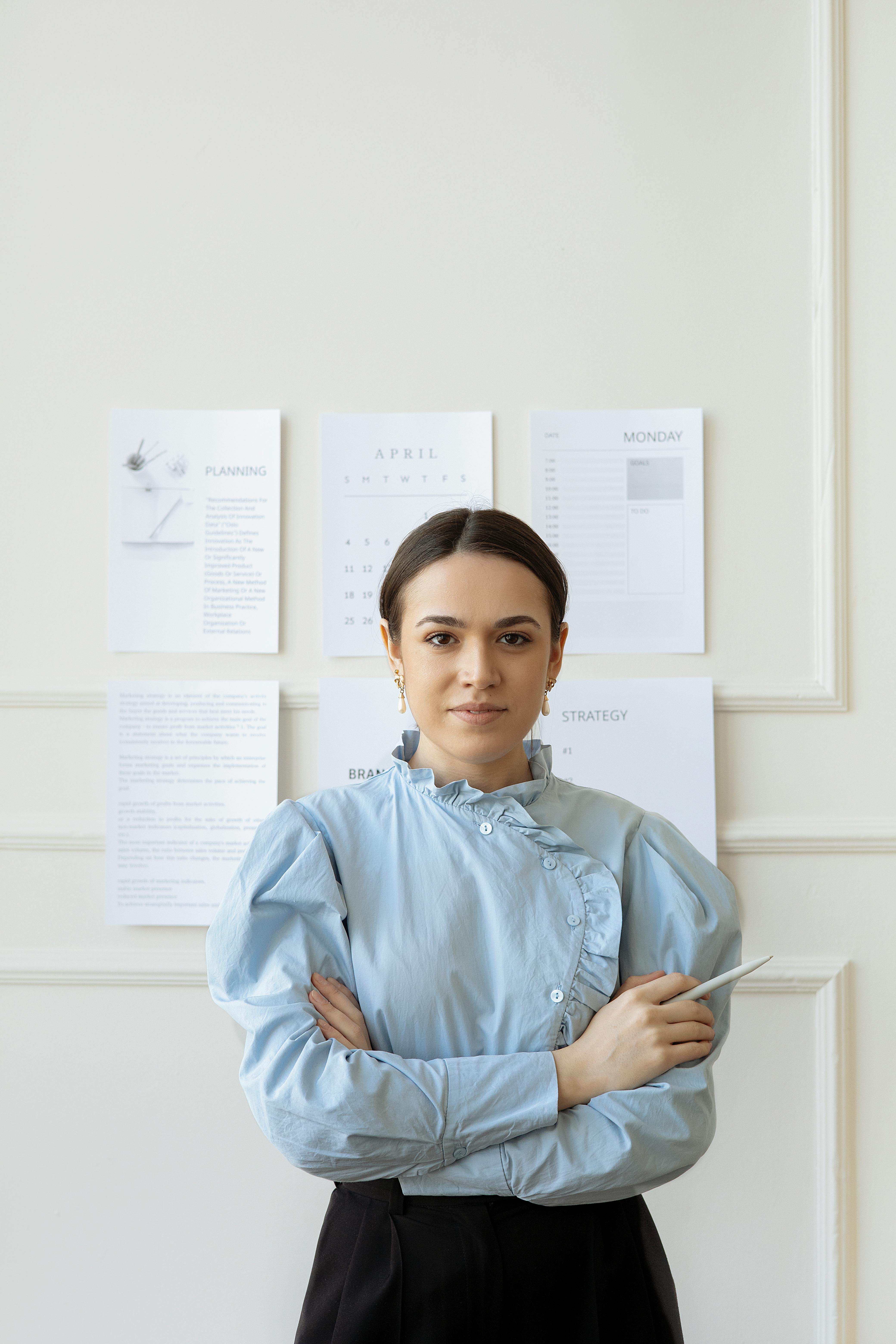 woman in blue long sleeve shirt with her arms crossed