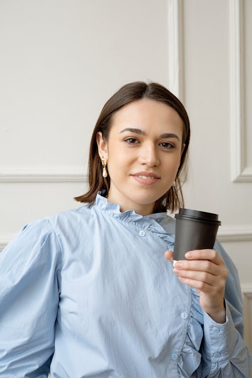 Free Woman in Blue Dress Shirt Holding Black Cup Stock Photo