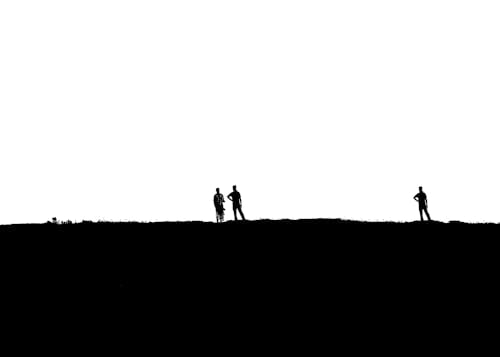 Monochrome Photo of People Standing