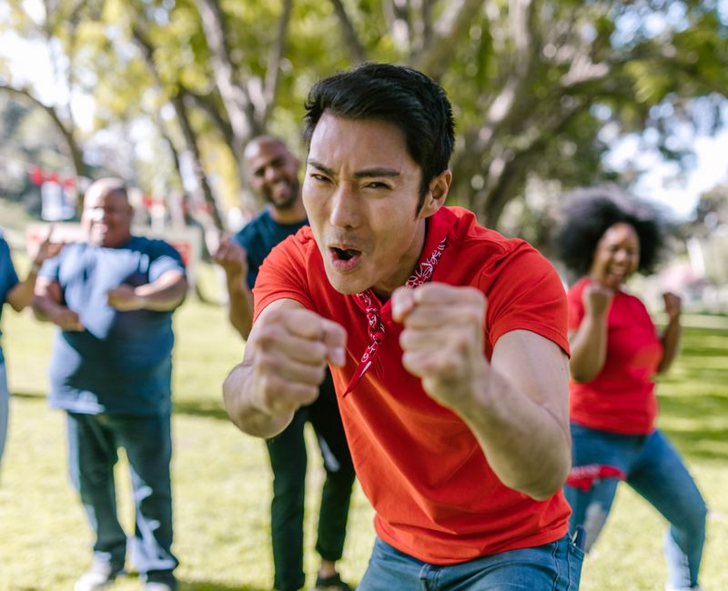 A diverse group of people engaging in a fitness event outdoors.