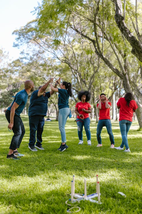 People Playing Ring Toss On Green Grass 