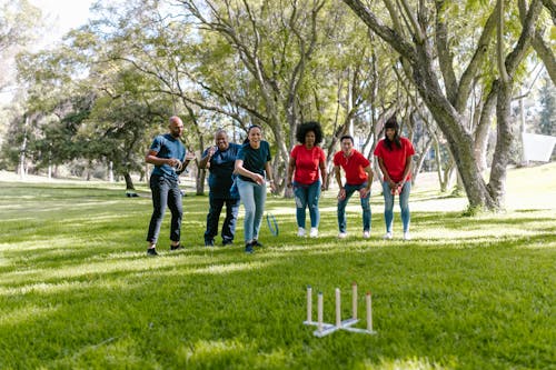 Group of People Playing Ring Toss On Green Grass