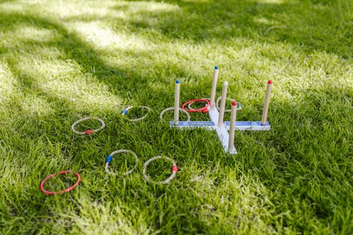Free Vibrant outdoor ring toss game set on lush green grass, perfect for summer fun. Stock Photo