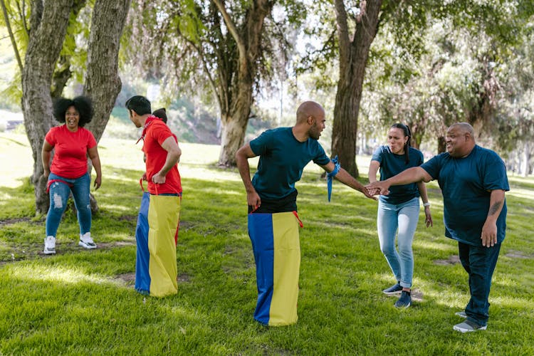 Men Playing Sack Race With Friends