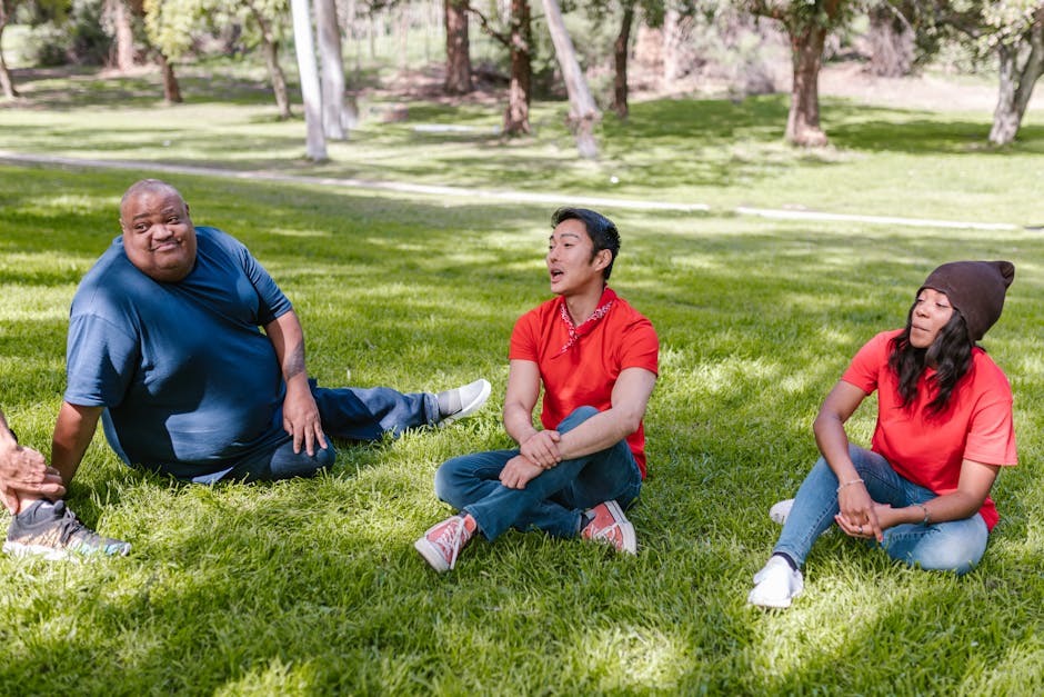 A diverse group of adults enjoying their time at a park, emphasizing relaxation and friendship.