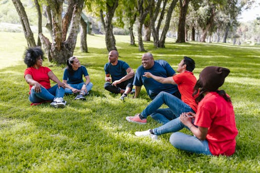 Multicultural group of friends bonding in a sunny park day, promoting unity and teamwork.