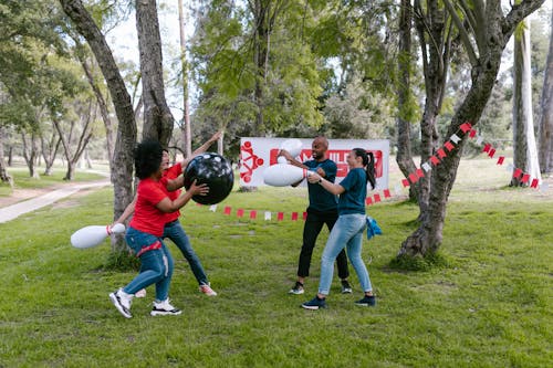 Two Teams Of Man And Woman Playing With Plastic Bowling Pins