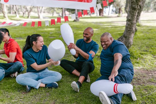 Man And Woman Playing With Plastic Bowling Pins