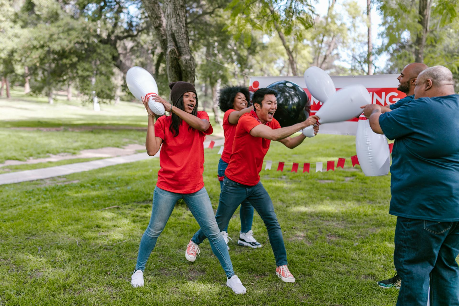 Group of People Playing With Plastic Bowling Toy