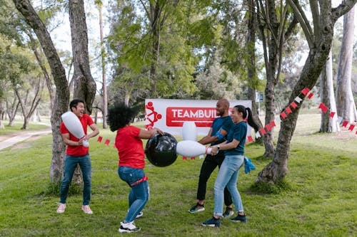 Group of People Playing With Plastic Bowling Toy