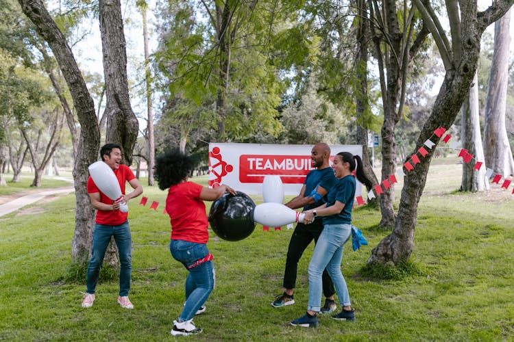 Group Of People Playing With Plastic Bowling Toy