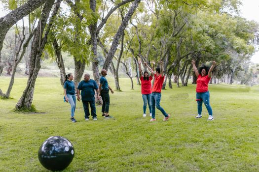 Diverse group enjoying a team-building activity outdoors, fostering fun, unity, and collaboration.