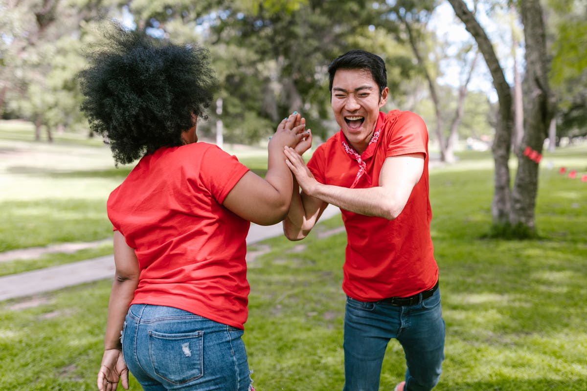 An older man smiling while participating in a group activity