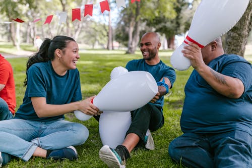 Group of People Playing With Plastic Bowling Pins 