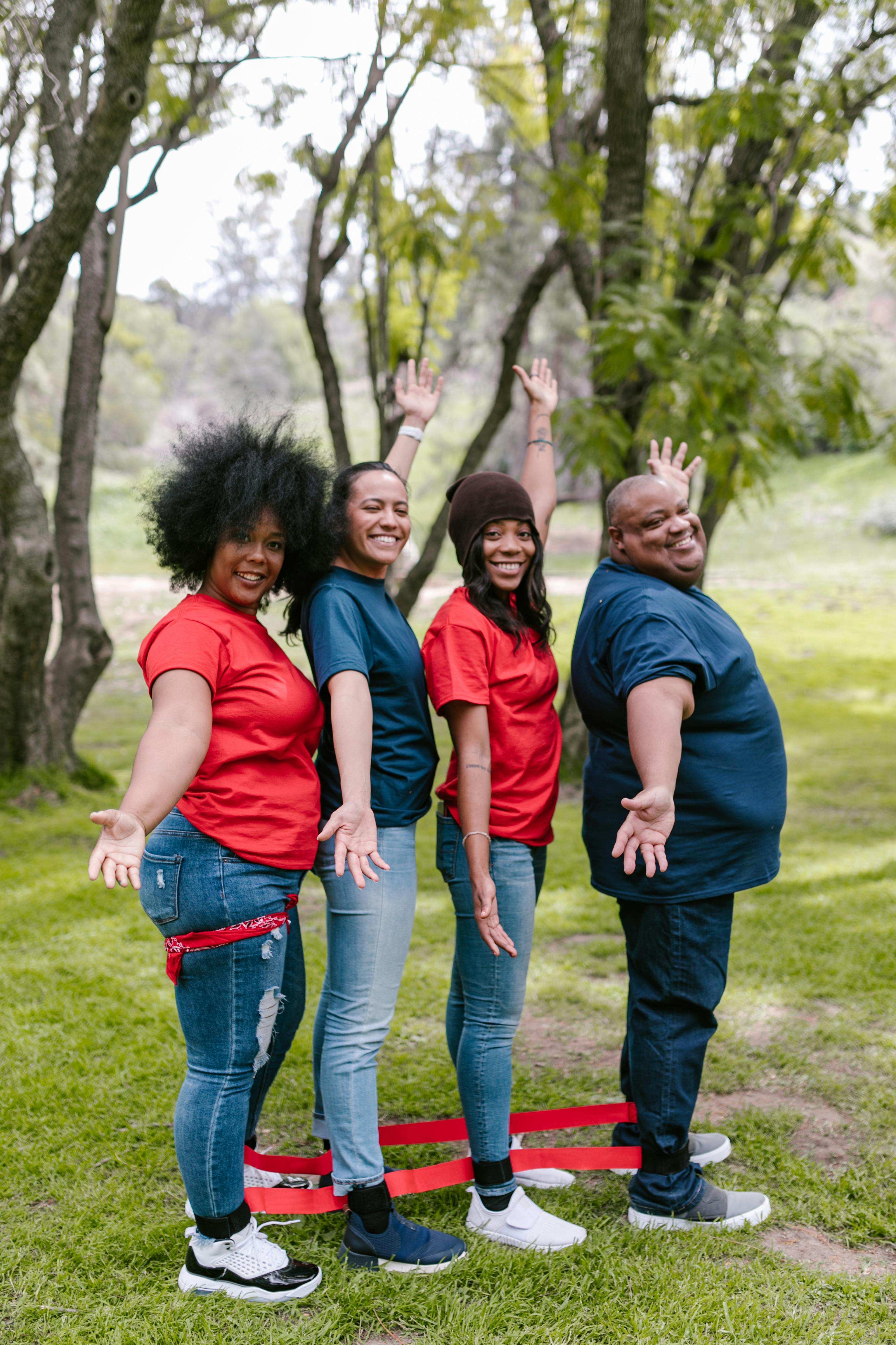 group of people standing on green grass field