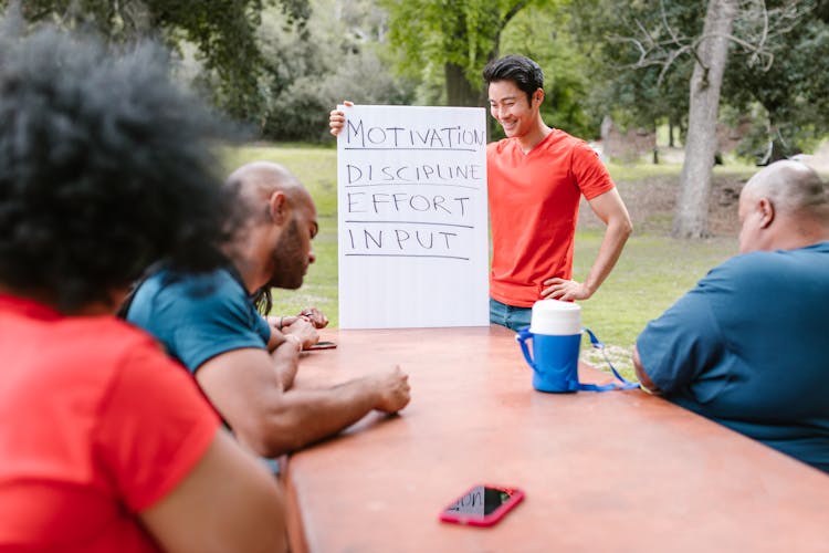 Group Of People Discussing Objectives Of A Team