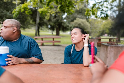 A diverse group of friends enjoying a sunny day at the park, depicting friendship and leisure.