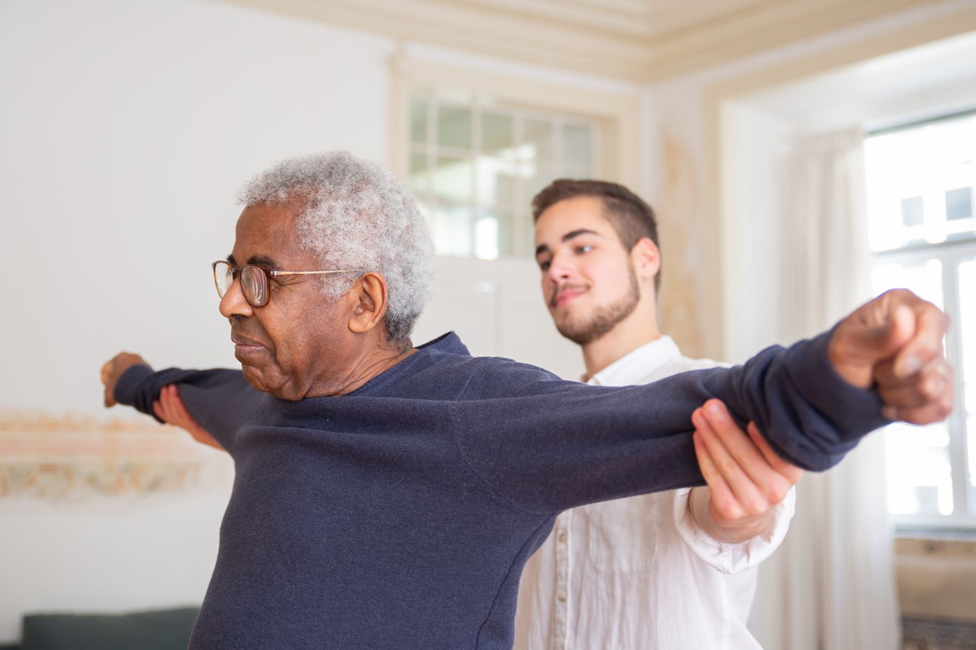 A home health nurse checking in with an older adult in her living room