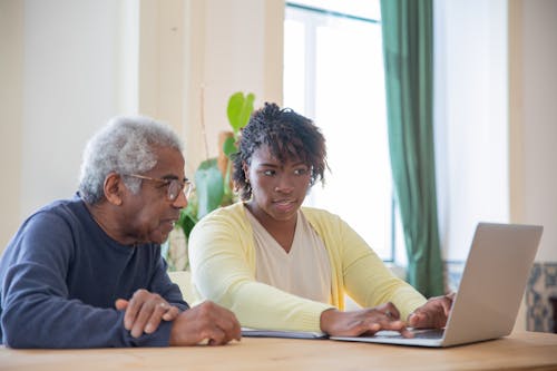 Free A Man and a Woman using a Laptop Together Stock Photo