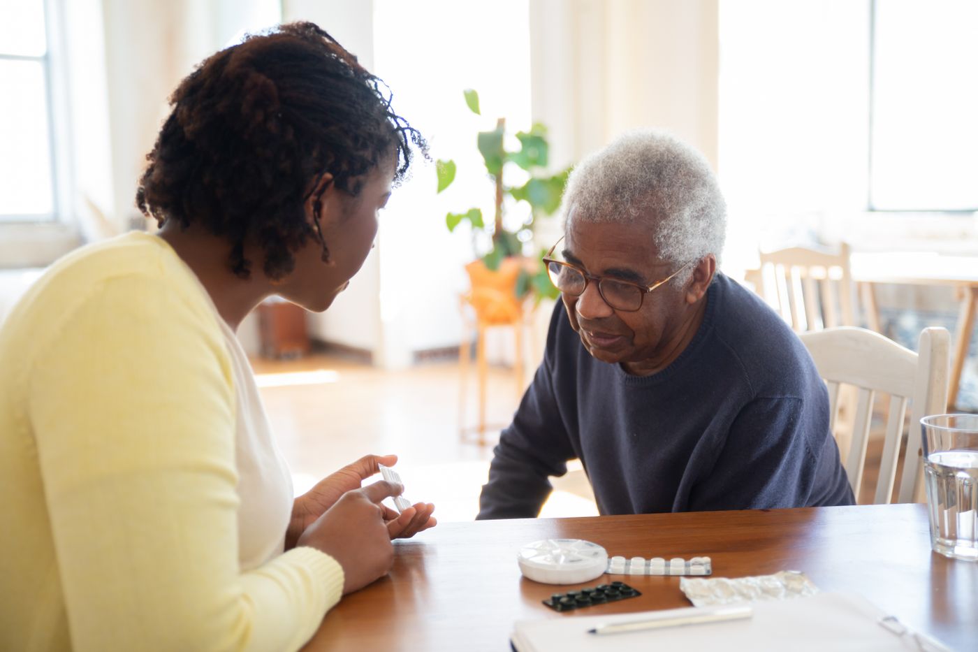 Family members review care notes together at a kitchen table