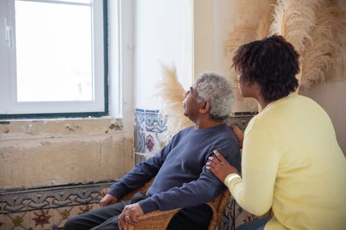 Free Elderly Man and Woman Looking Outside Window Stock Photo