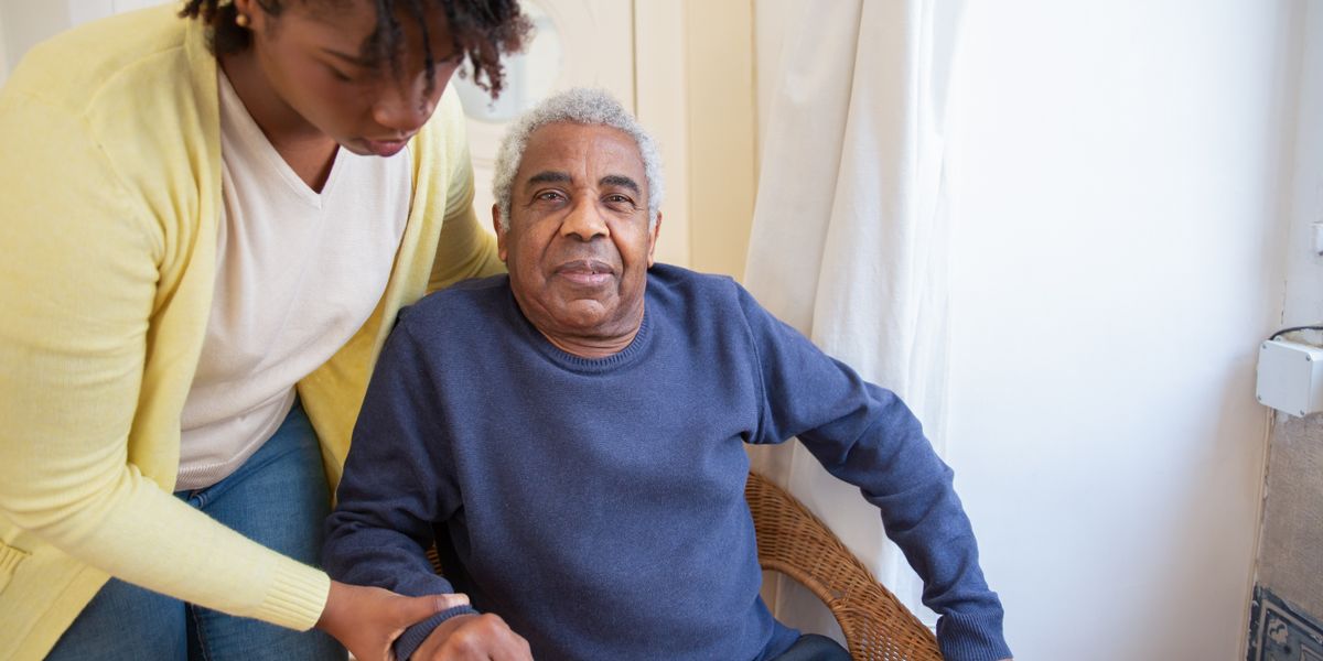 Caregiver warmly interacting with a senior in a comfortable living space