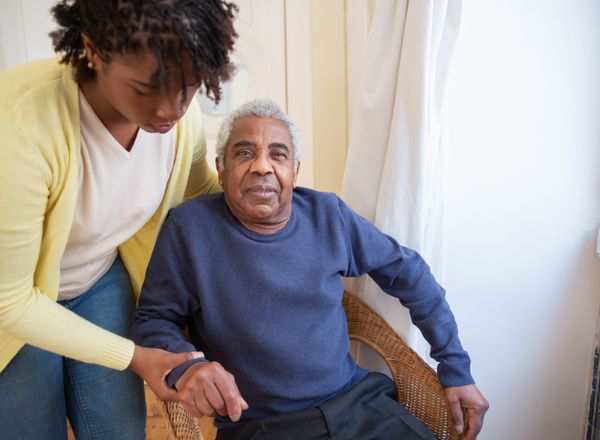 Caregiver providing attentive personal care to a senior at home