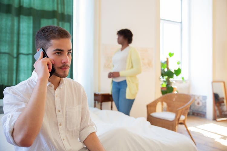 Man In White Button Up Shirt Holding Black Smartphone