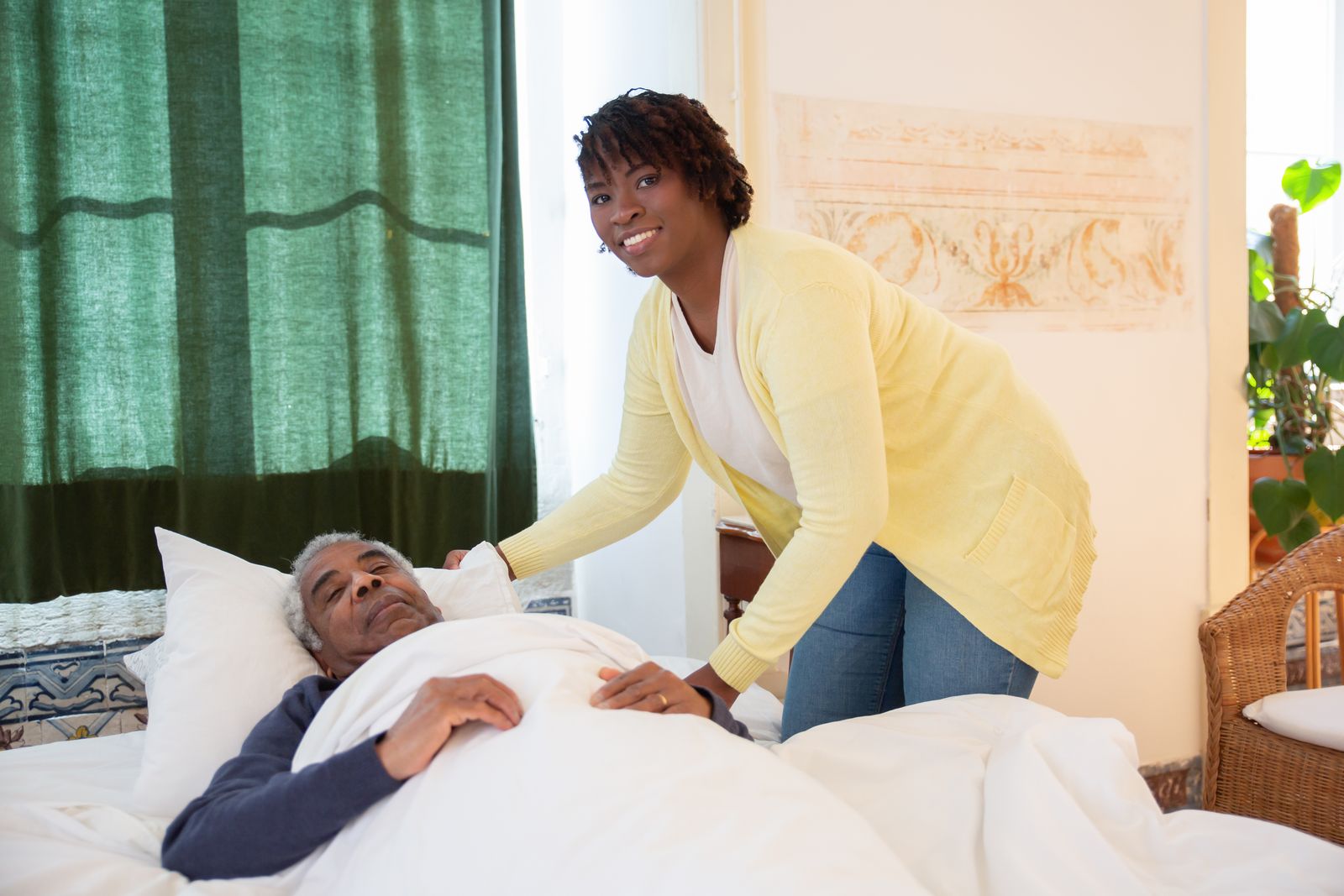 An older adult and a younger relative share a calm moment at home after a planned break for the primary caregiver.