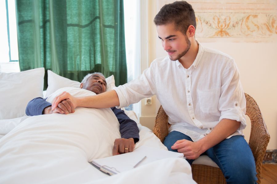 Nurse comforting elderly patient