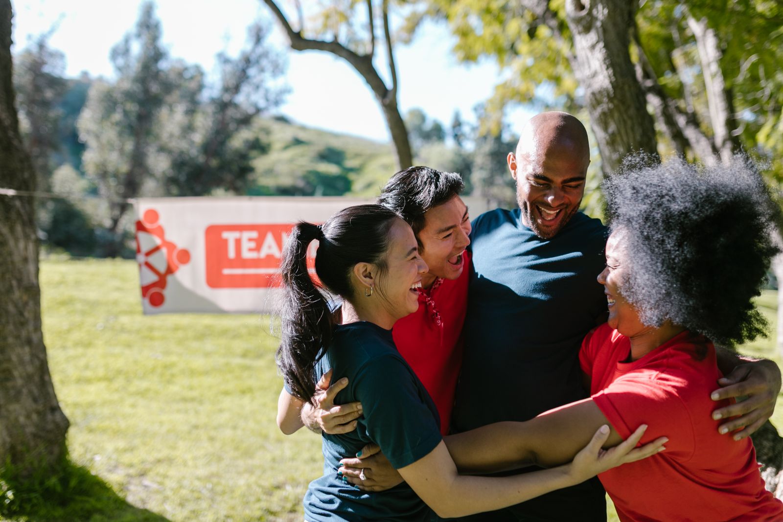 Smiling members of a partner organization celebrating together outdoors