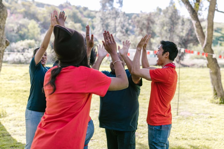 Two hands gently held — care worker and participant