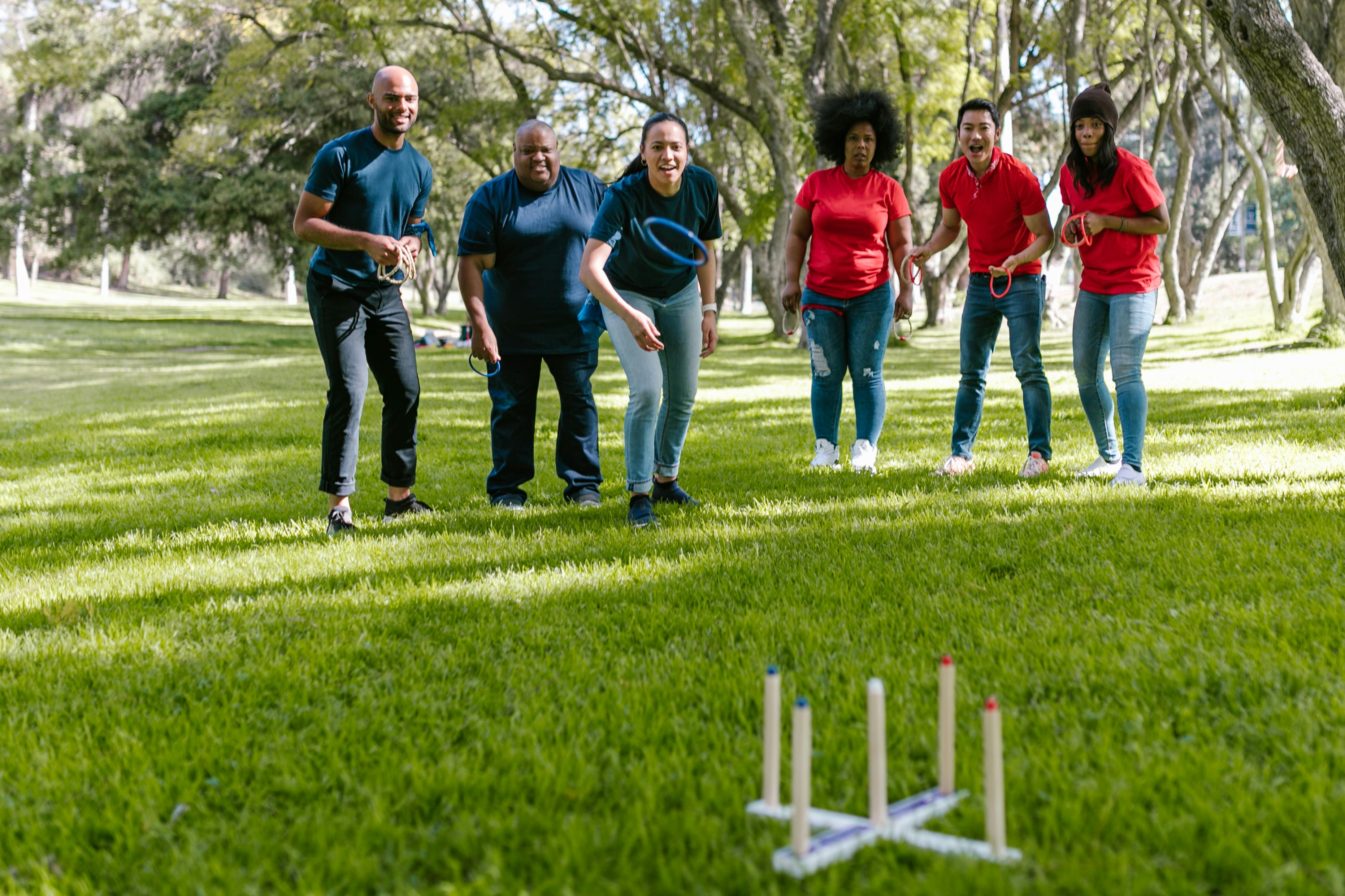 group of people playing on green grass field