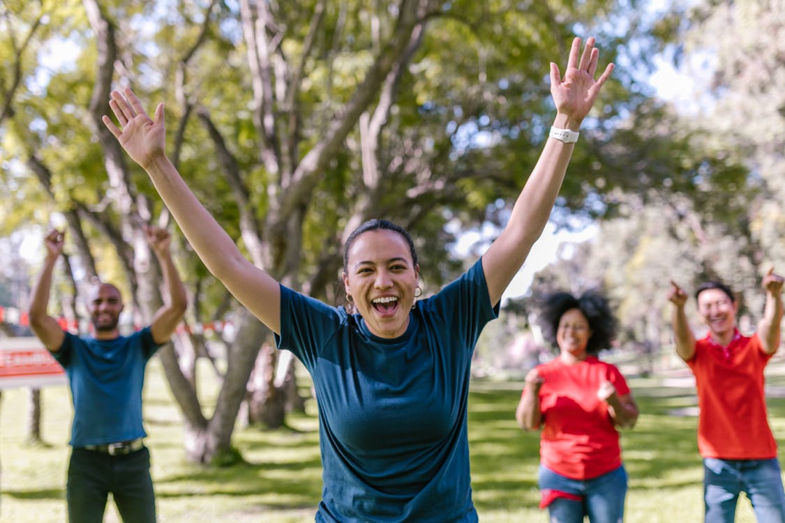 Woman In Blue Crew Neck T-shirt Raising Her Hands