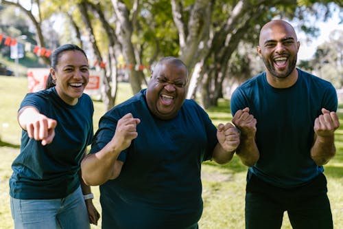 Free Three People In Blue Crew Neck Shirts With Happy Faces Stock Photo