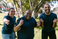 Three People In Blue Crew Neck Shirts With Happy Faces