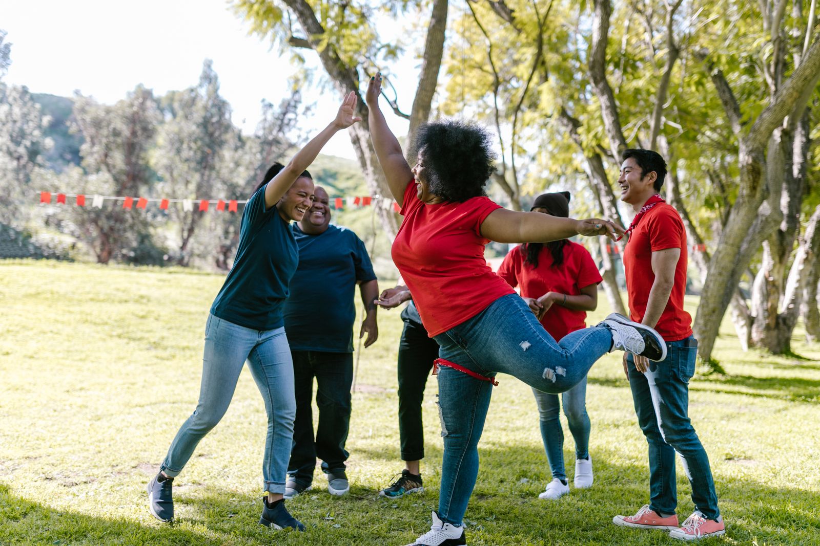 Smiling members of a partner organization celebrating together outdoors