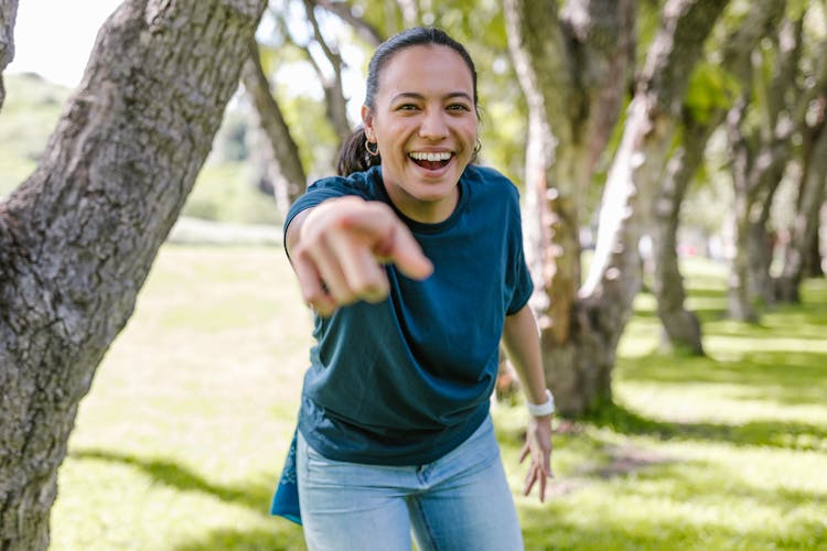 A Woman Smiling While Pointing