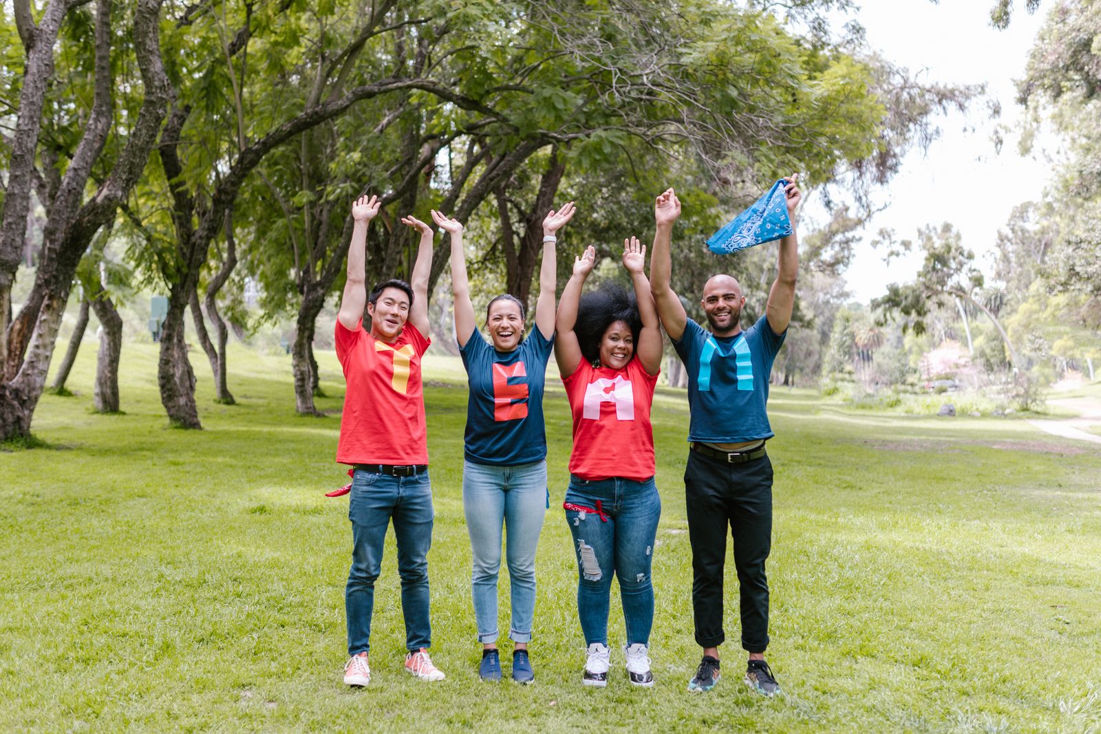 Smiling members of a partner organization celebrating together outdoors