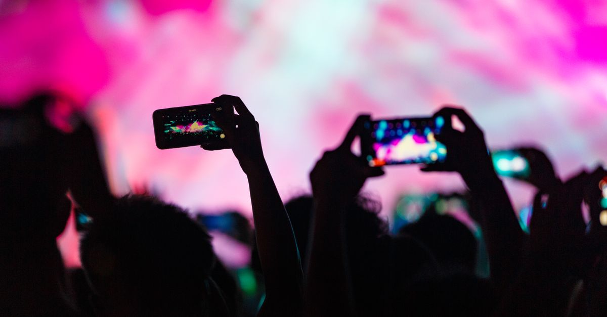 concert crowd holding up phones with TikTok interface overlay