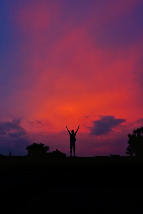 Silhouette of a Person Raising His Arms