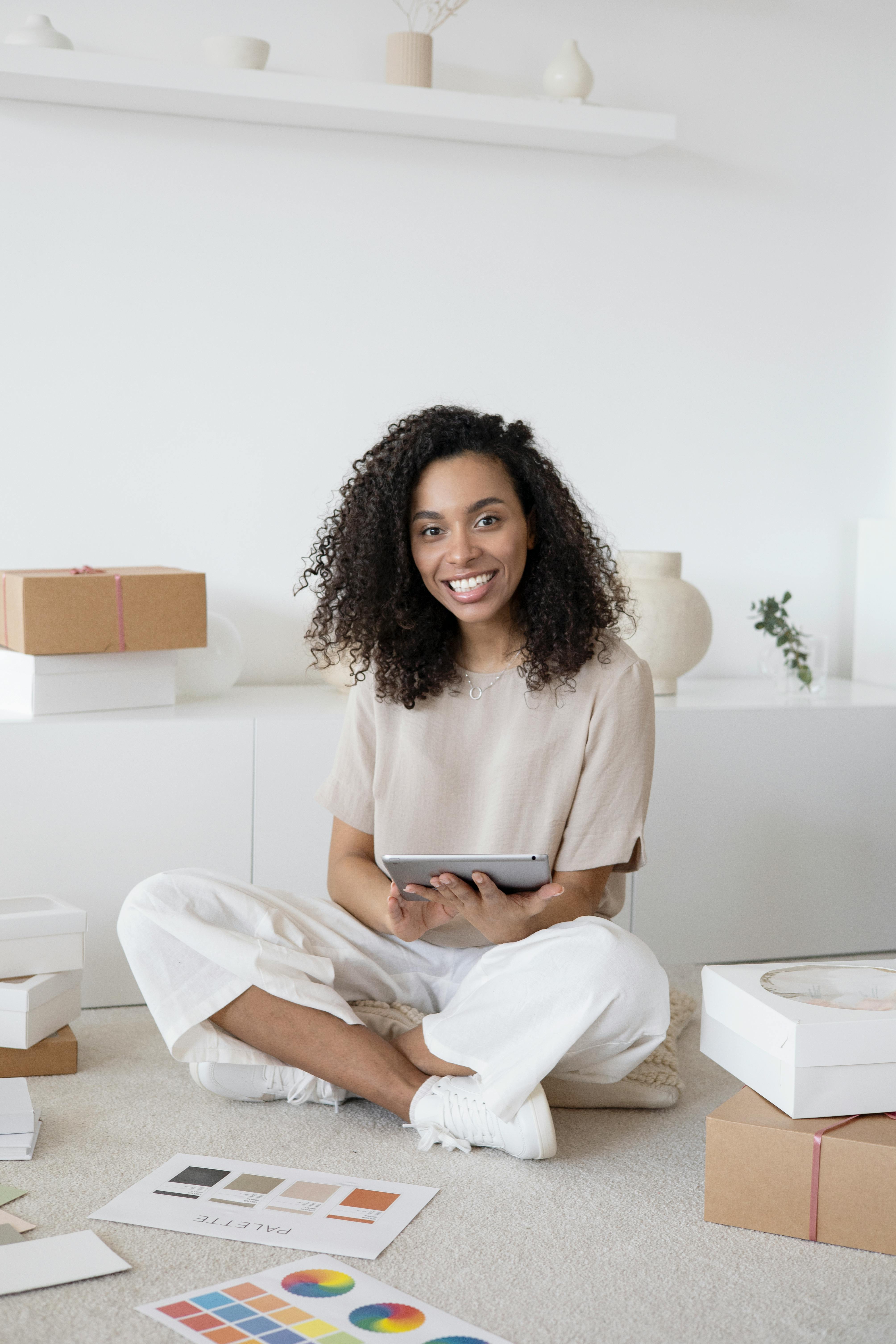 woman in white dress shirt sitting on white table