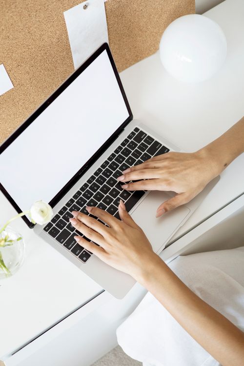 Free Elegant minimalist workspace showing hands typing on a laptop in a bright setting. Stock Photo