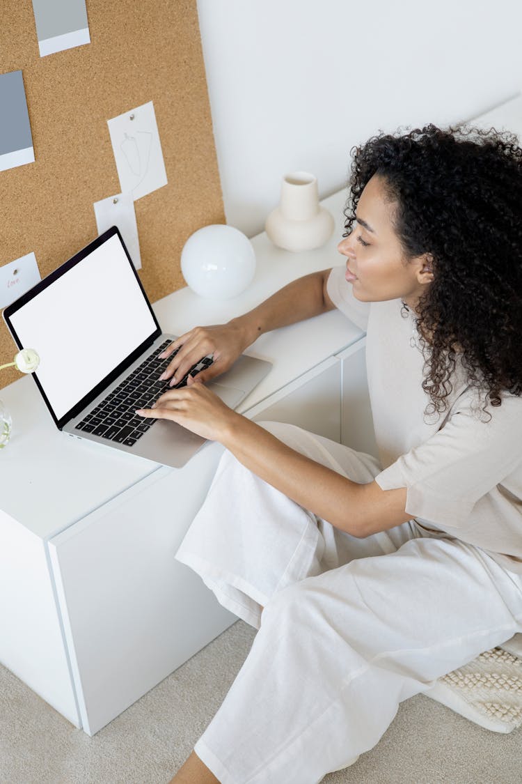 A Woman Typing On Her Laptop