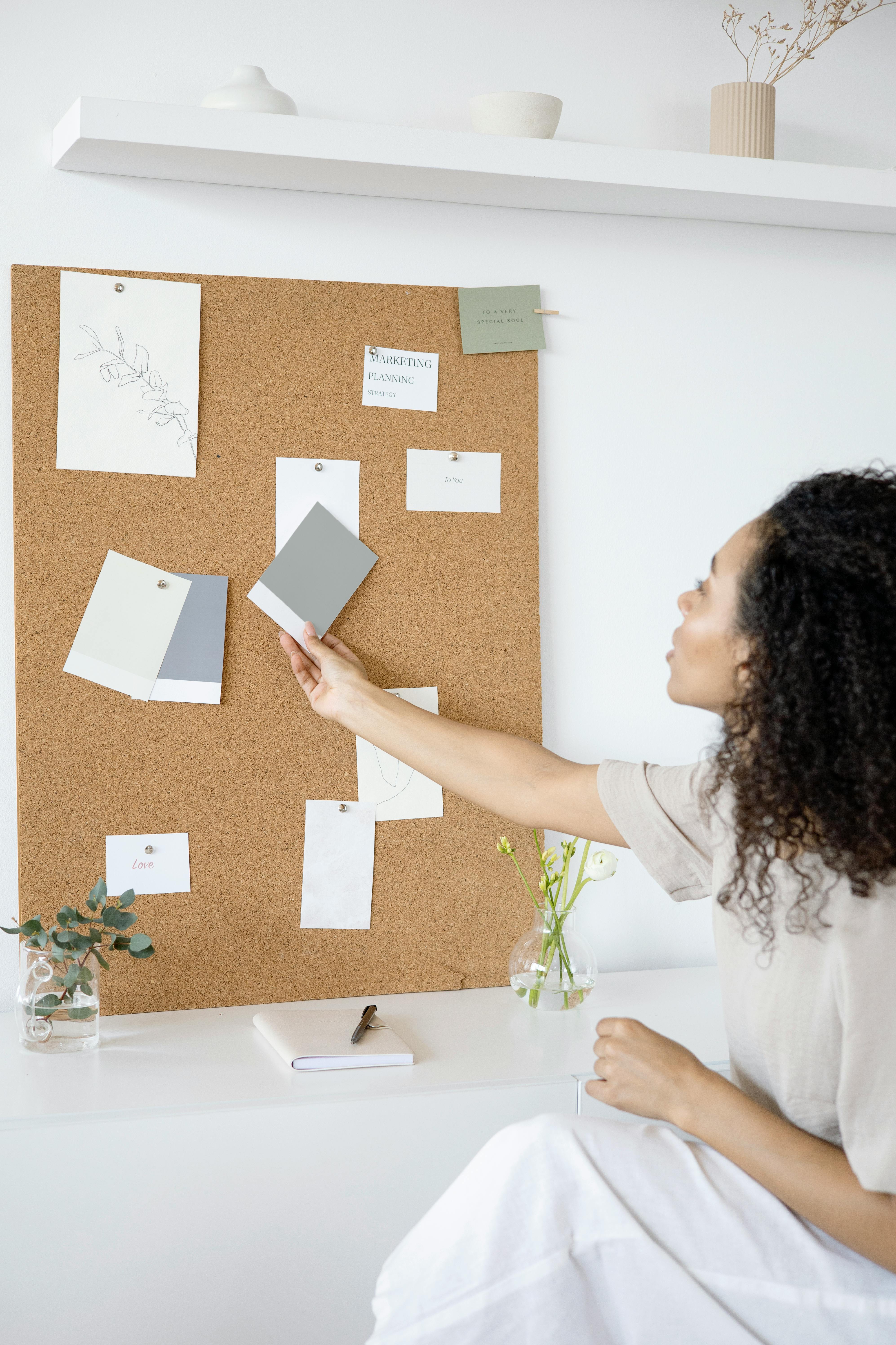 woman in white shirt holding white printer paper