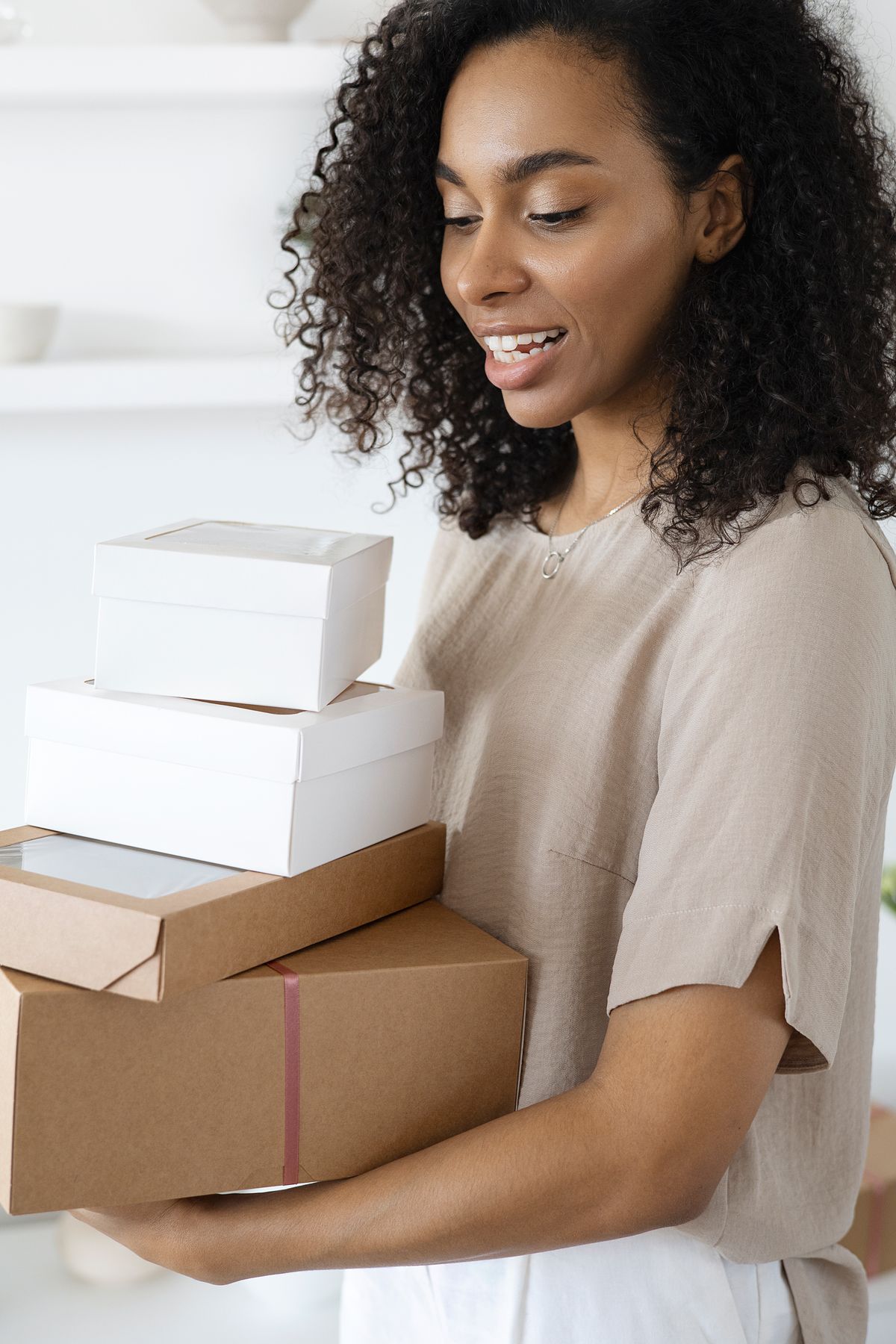African online shop owner holding parcels ready to ship